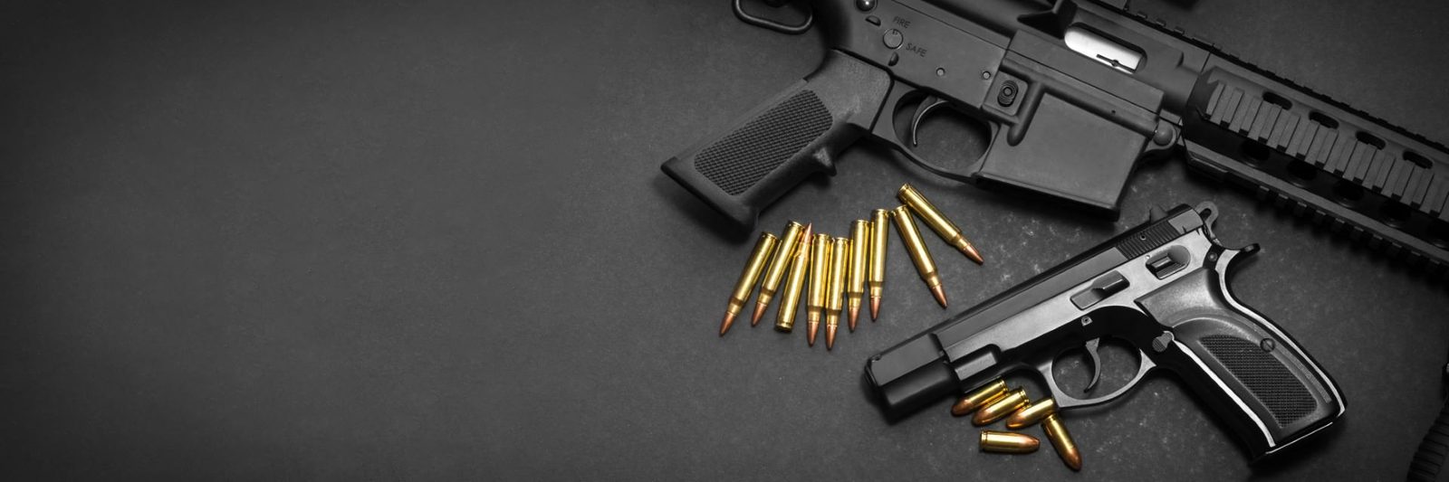 Results-Driven SEO Handgun, rifle, and ammunition arranged on a dark surface